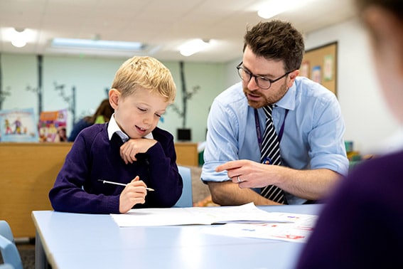 Teacher supporting pupil learning