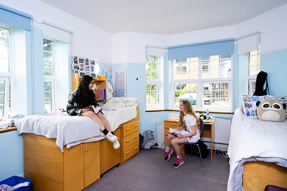 Two school girls in bedroom