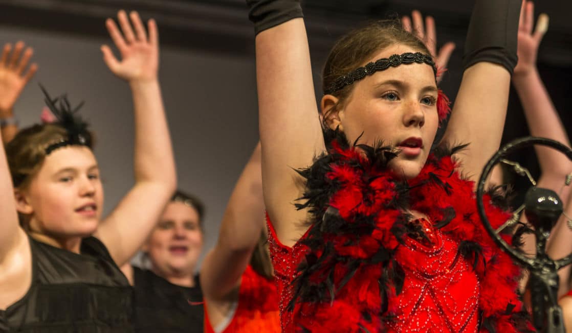 School girl in theatre performance dressed in costume