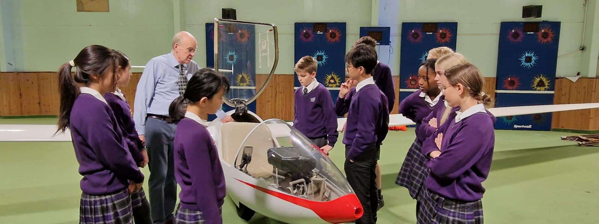 Prep school children observing glider plane