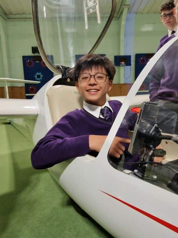 Prep school boy sat in glider during discovery activity