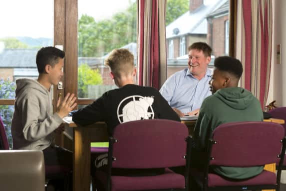 Group of Senior School boarding boys with house parent