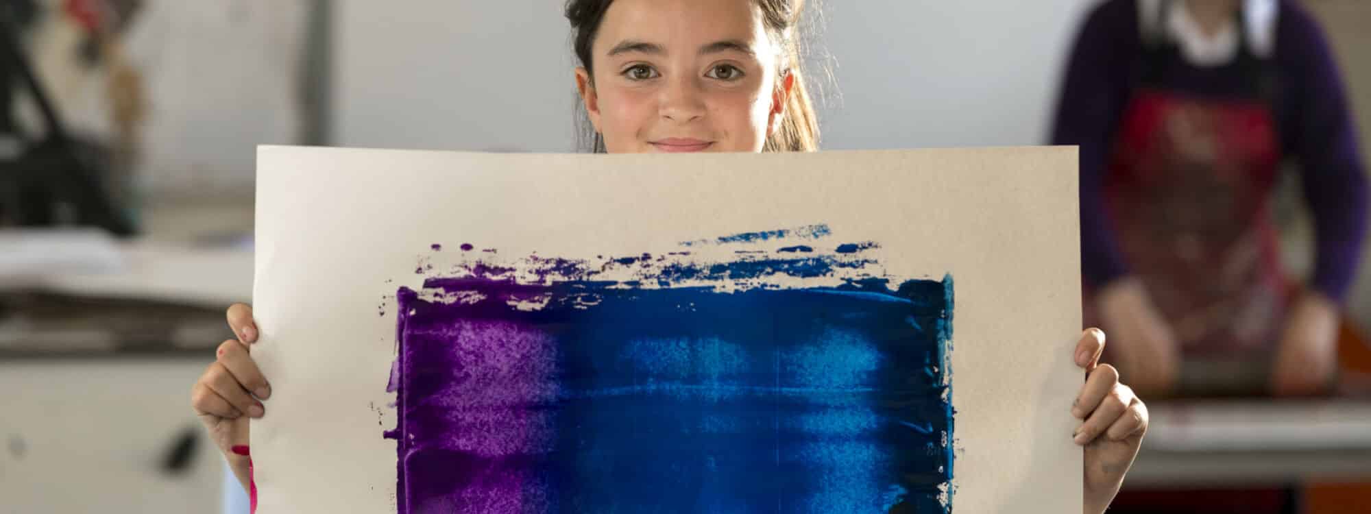 School pupil holding art