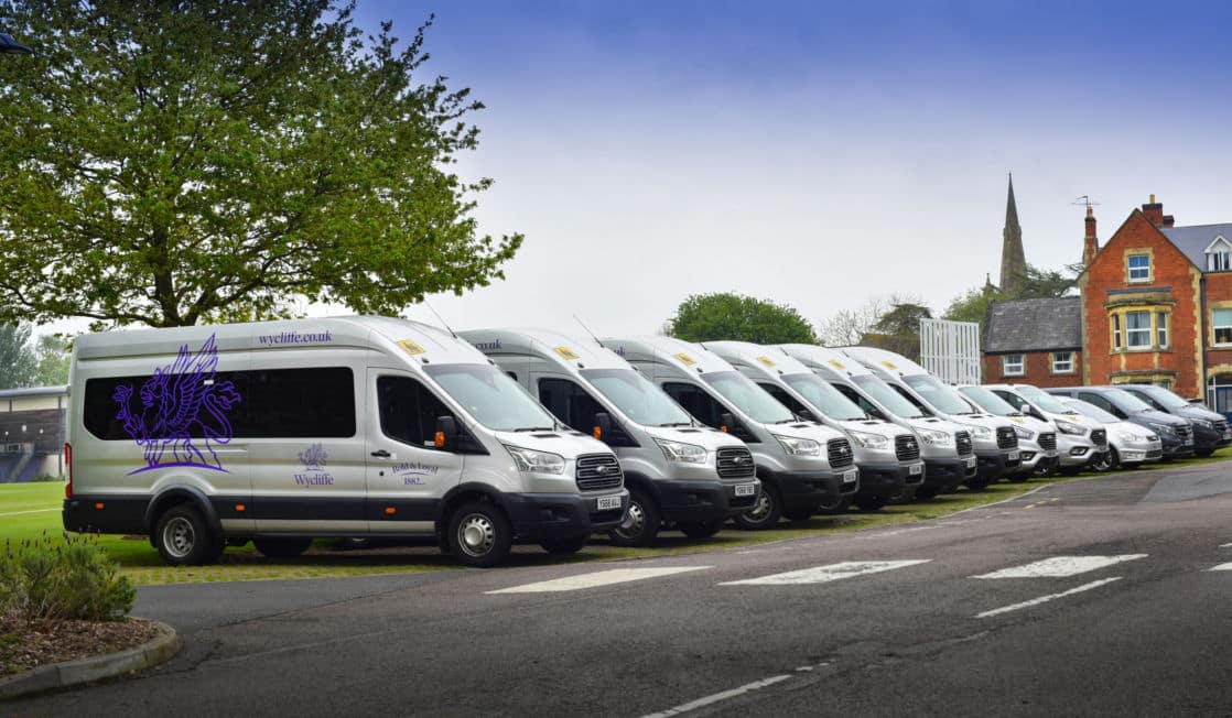 Fleet of Wycliffe branded silver and purple school buses