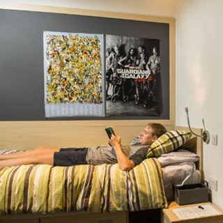 Boarding boy reading on bed