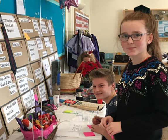 Girl and boy school pupils participating in challenge