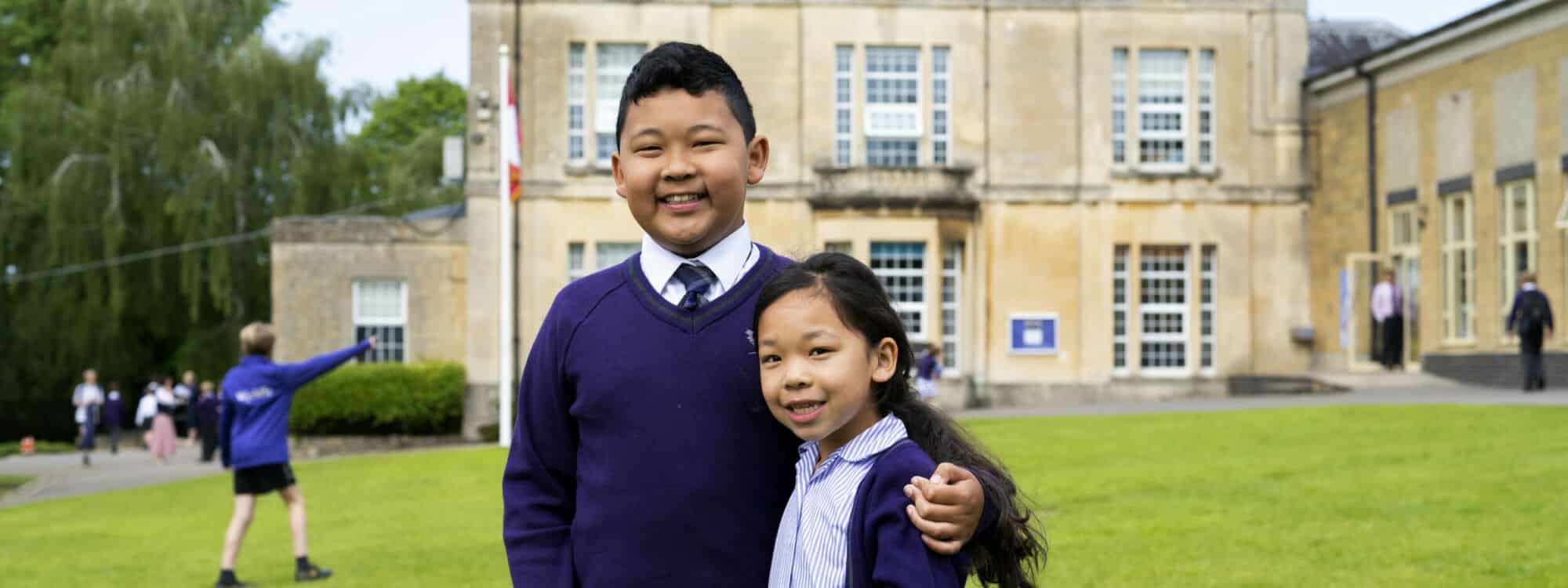 Elder international Brother with arm around younger sister