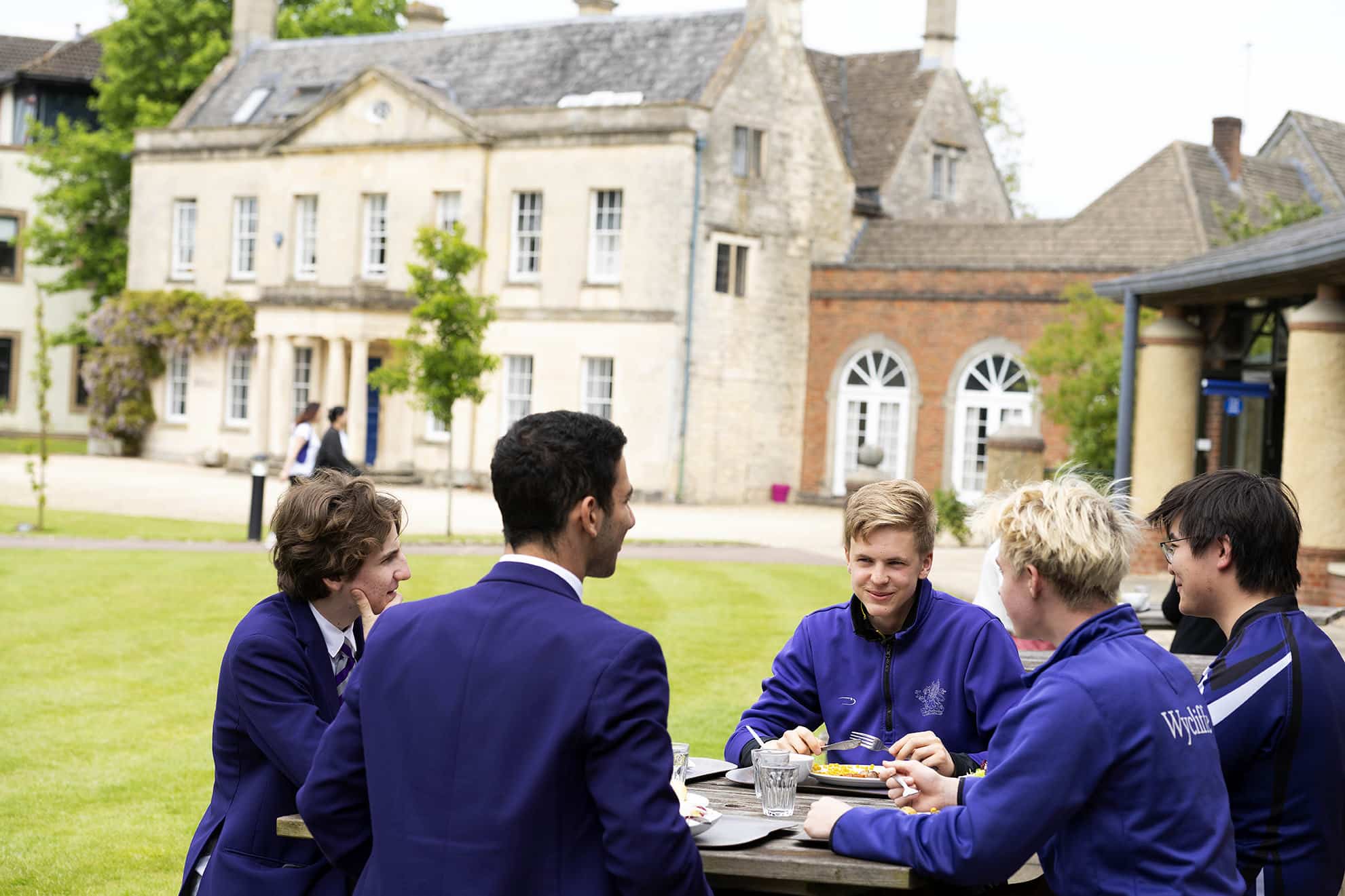 Group of senior school boys sat outside