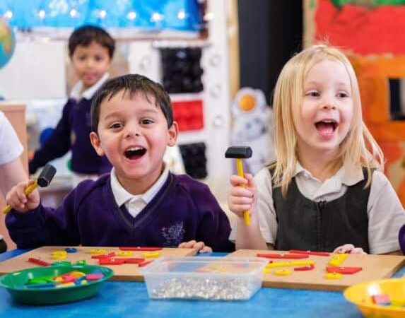 nursery and pre prep children girl and boy playing with discovery toys