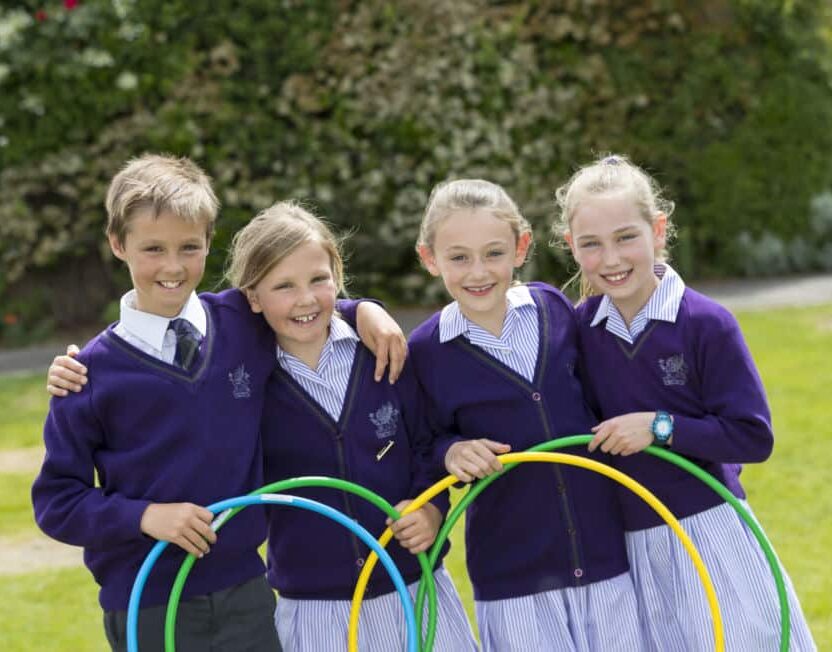 Three girls and a boy holding hoops