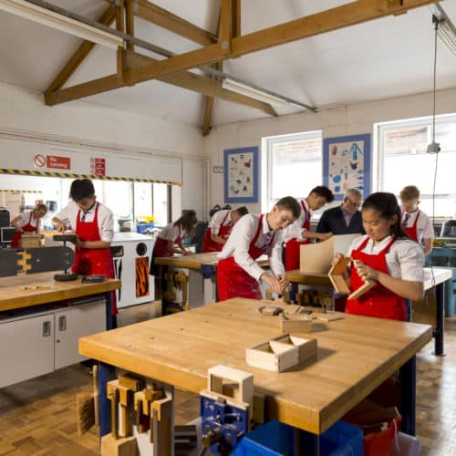 School pupils participating in woodwork activity