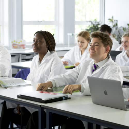 School pupils in white science laboratory jackets