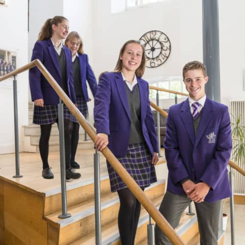 School pupils standing on stairs